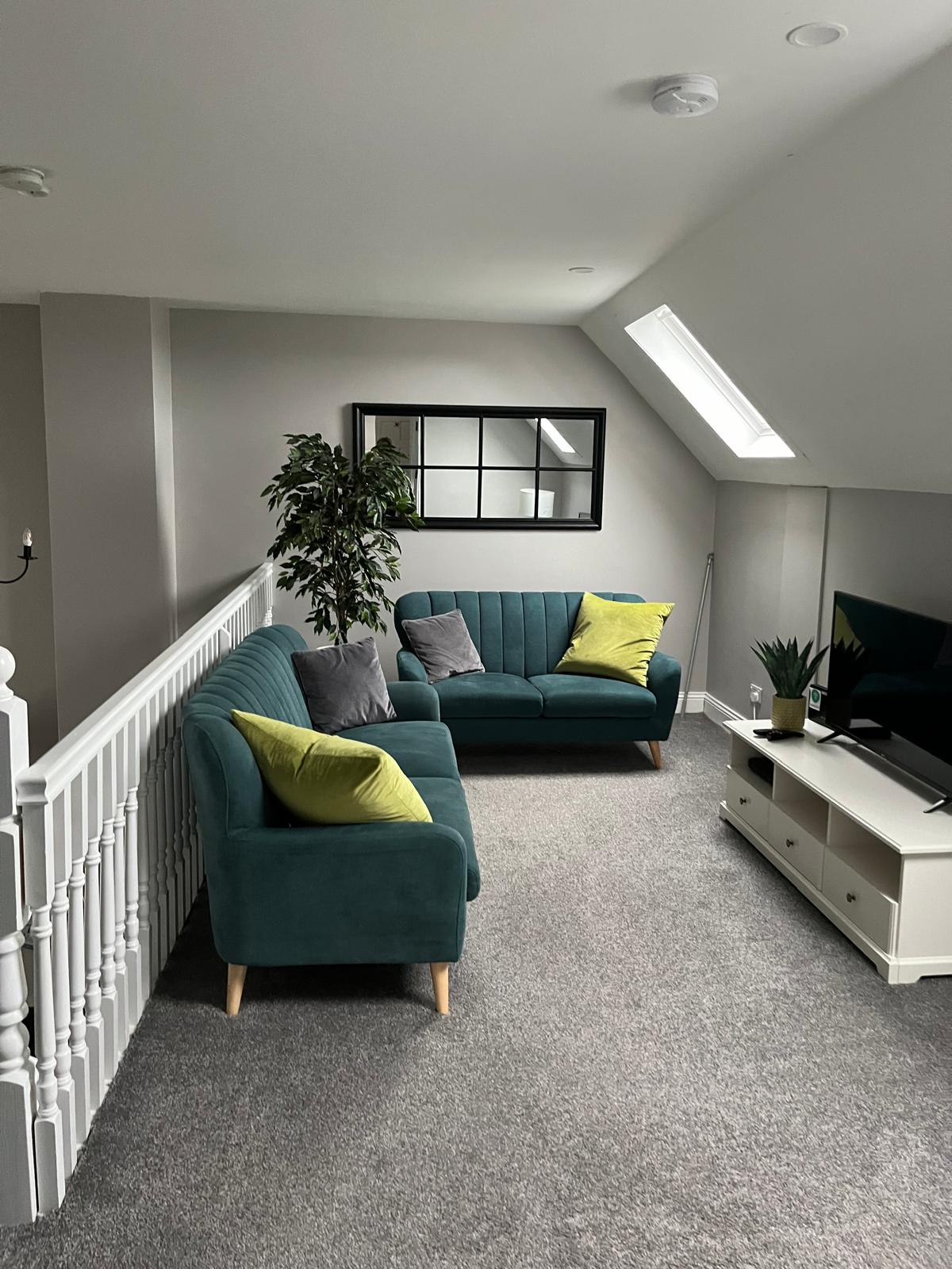 Tidy upstairs lounge with vacuumed carpet